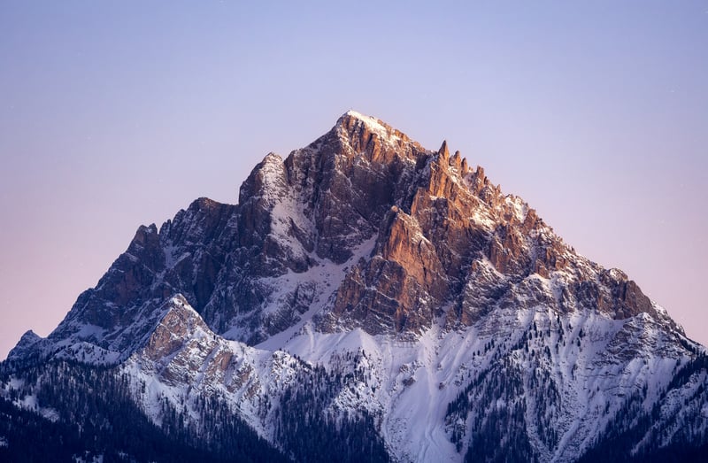 Snow-covered mountain peak at sunrise