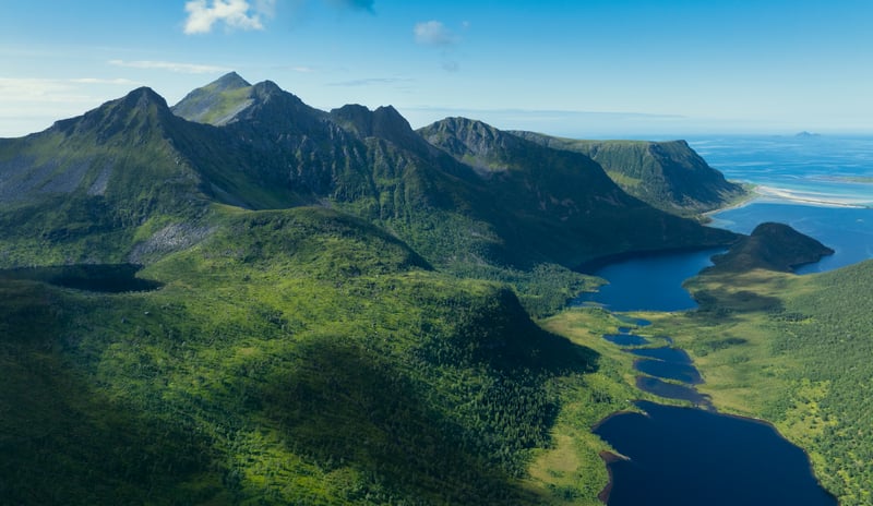 Aerial view of mountains and lakes in a green landscape