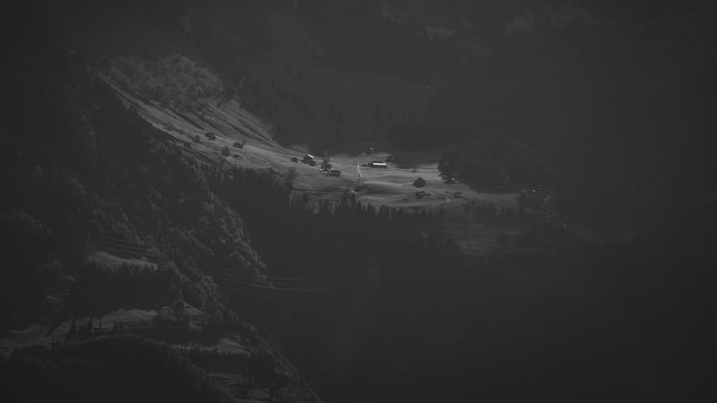 Monochrome aerial view of a village in a mountainous landscape