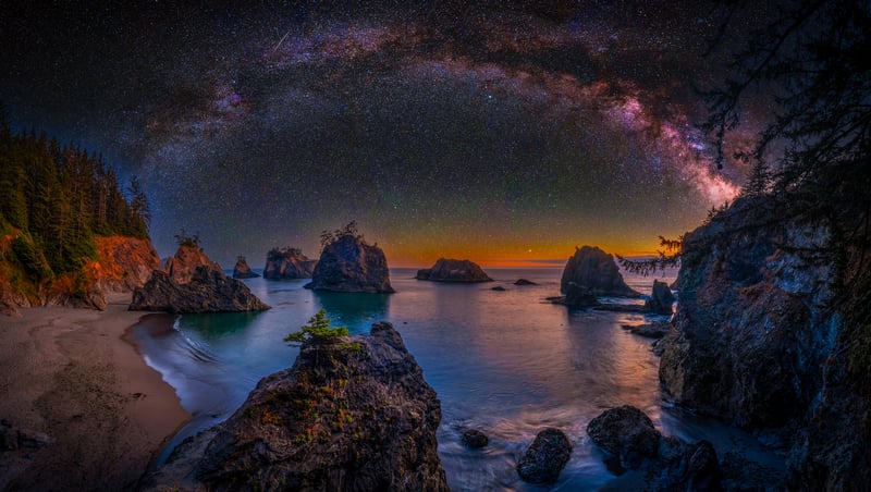 Milky Way over rocky coast at night