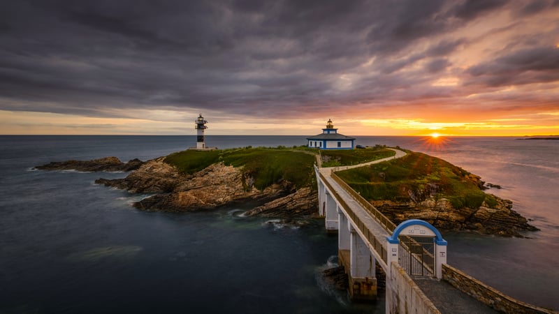 Island lighthouse and bridge at sunset