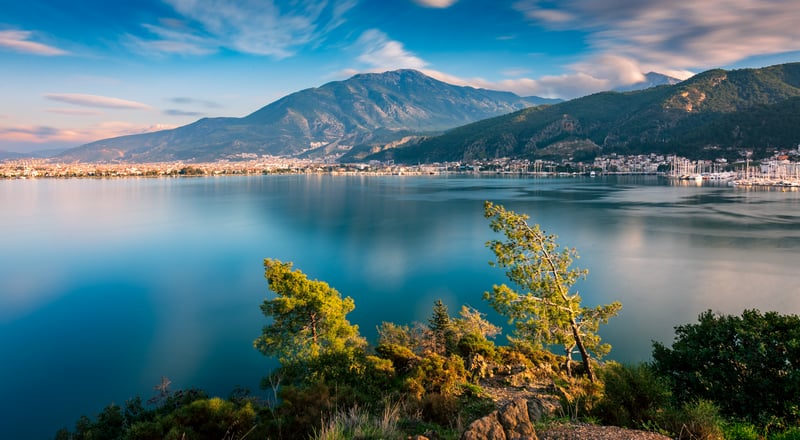 Lake with mountains and trees in the foreground