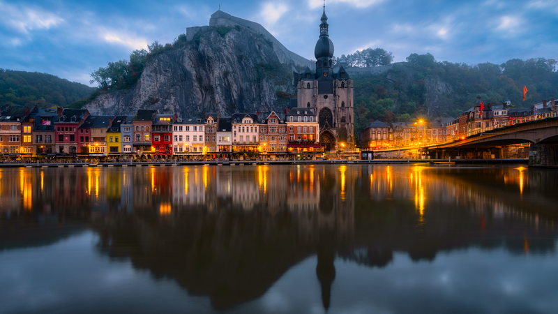 Town reflected in river during blue hour