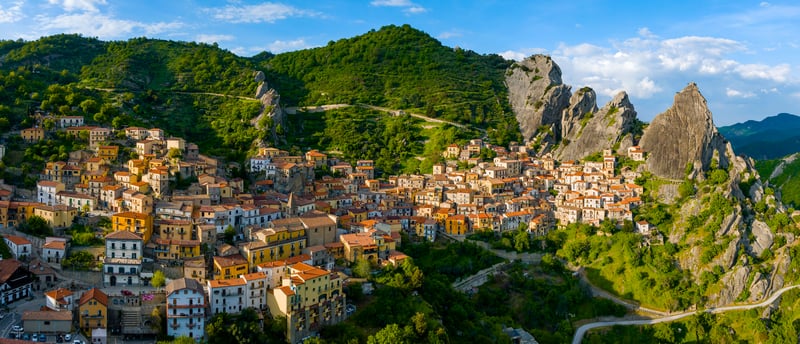 Village nestled in a green mountain landscape