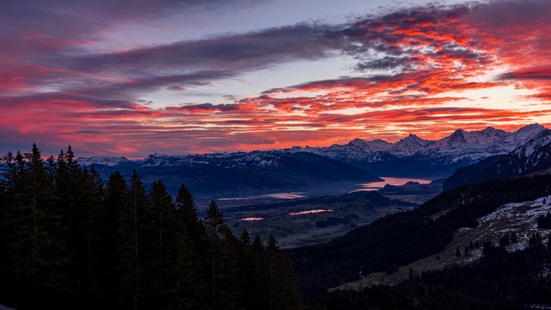 Sunset over snow-capped mountains and lakes