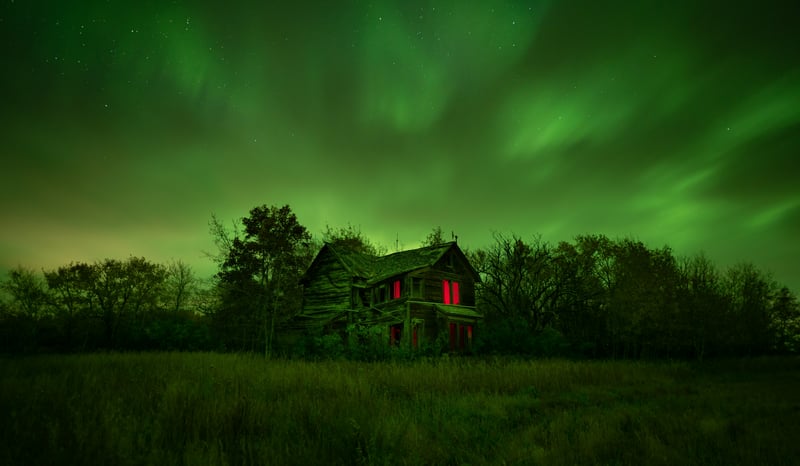 Abandoned house under the aurora borealis