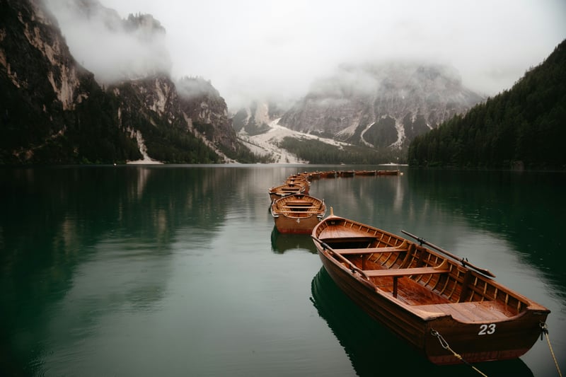 Boats on a misty mountain lake