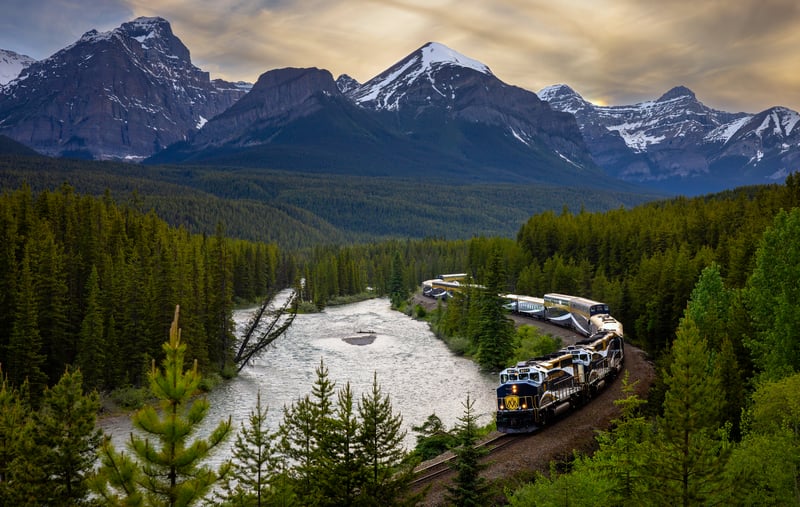 Train traveling through a mountain landscape with a river