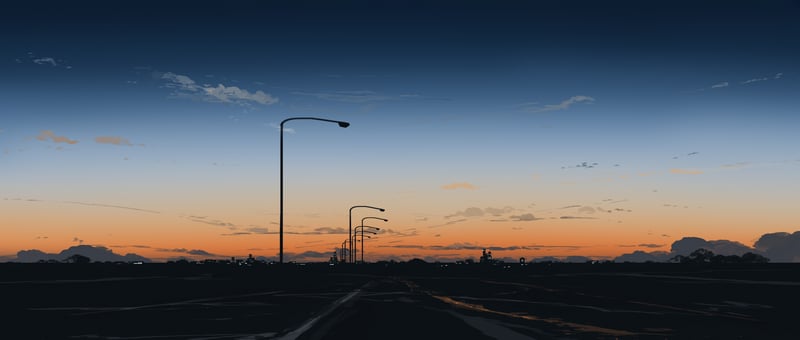 Streetlights on a road at sunset