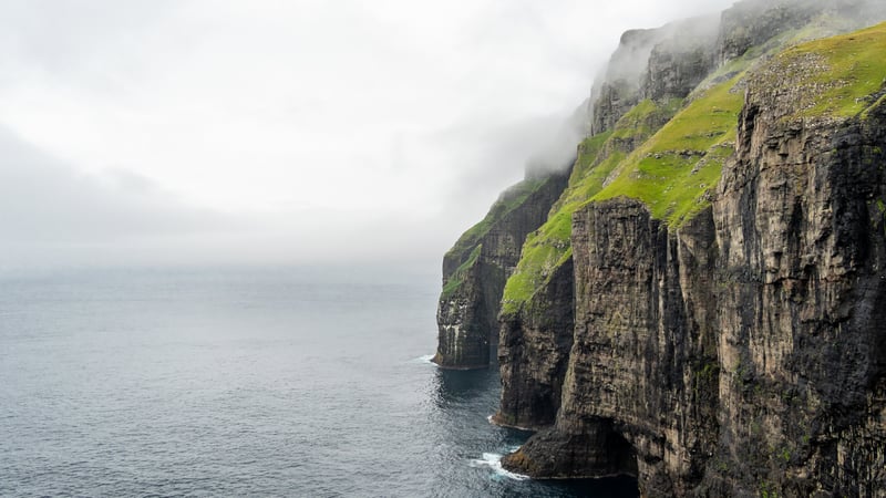 Misty cliffs overlooking the sea in the Faroe Islands