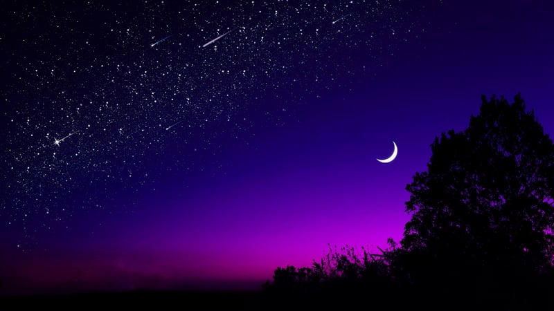 Night sky with crescent moon and shooting stars