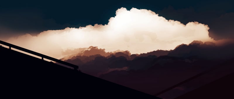 Dramatic clouds over silhouetted structures