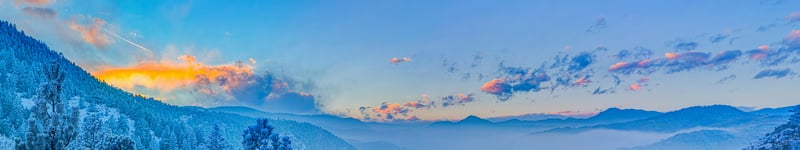 Misty mountains with clouds at sunrise