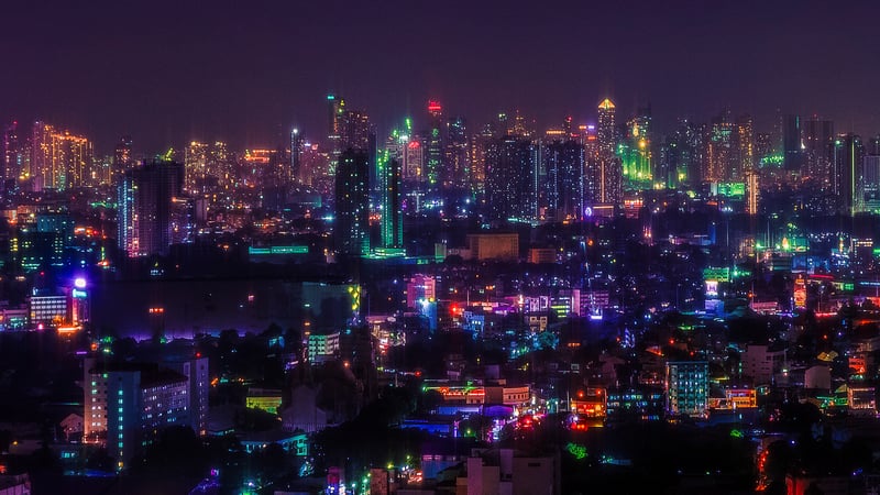 City skyline at night with glowing lights