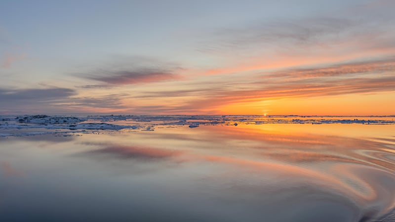 Arctic sunset over icy sea with colorful clouds
