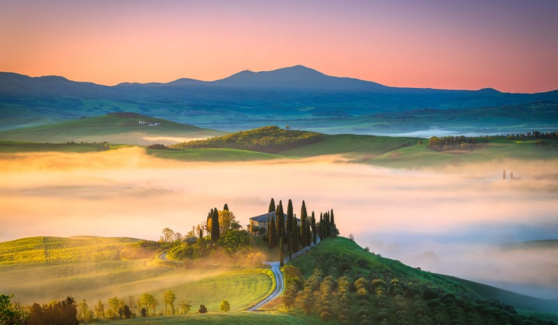 Misty Tuscan landscape with rolling hills and cypress trees