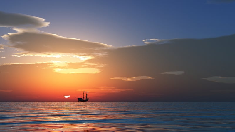 Ship sailing on the ocean at sunset