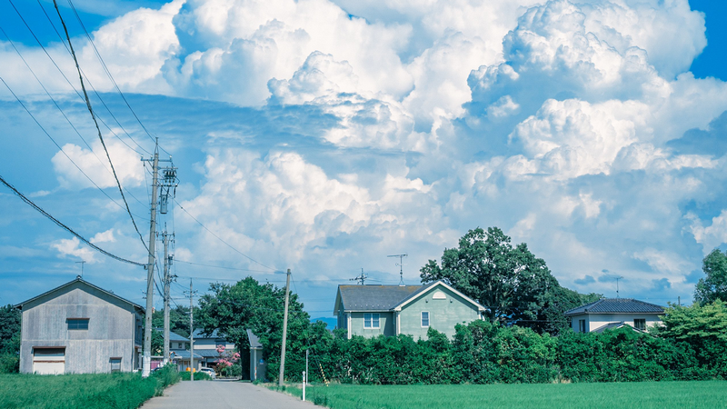 Houses and power lines under a cloudy sky in Japan