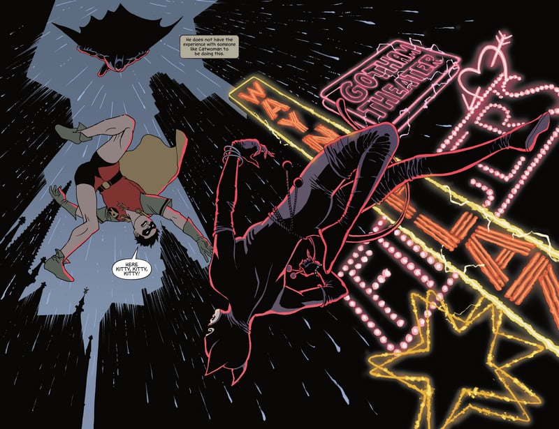 Robin and Catwoman fall near Gotham Theater neon signs