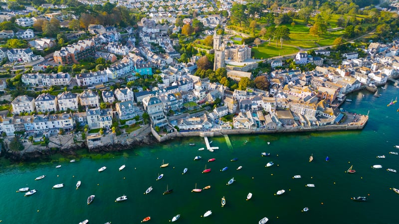Boats moored in a coastal town with a church