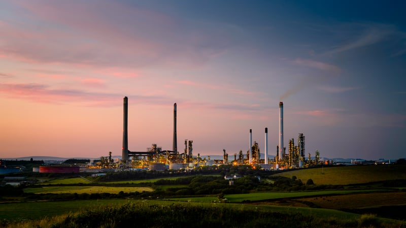 Industrial plant with chimneys at sunset