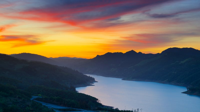 Sunset over a mountain lake with colorful sky