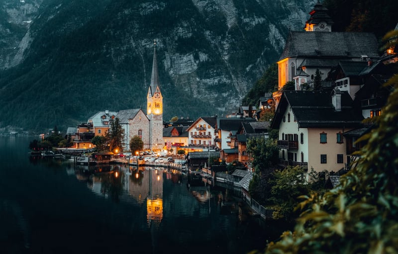 Hallstatt village with church reflected in water at night