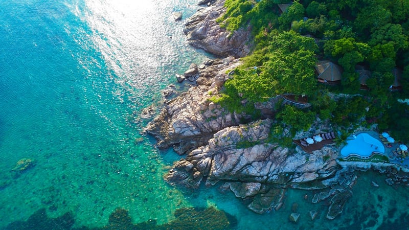 Aerial view of rocky coastline with turquoise sea