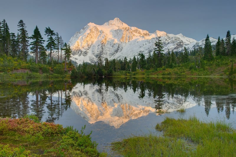 Snow-capped mountain reflected in a calm lake