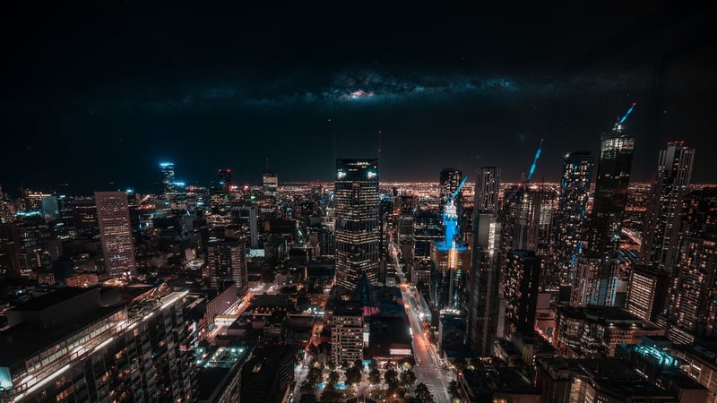 Cityscape at Night with Milky Way Galaxy Above