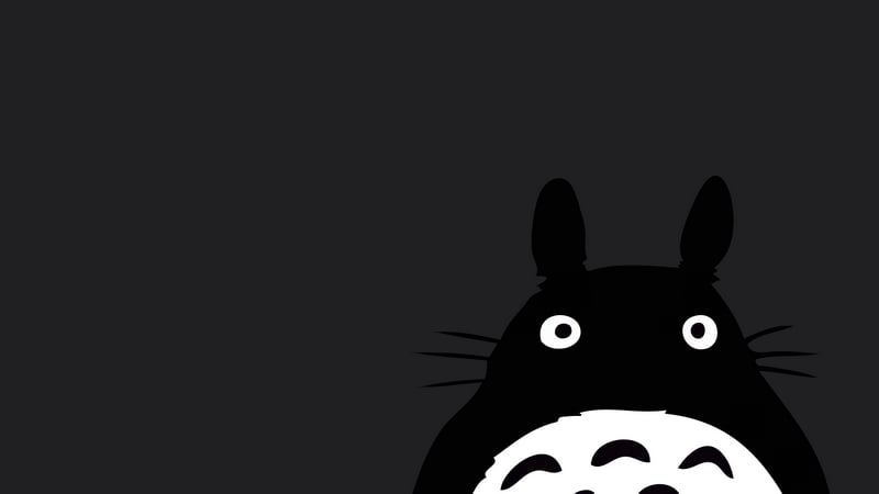 Totoro peeking from the side on a gray background