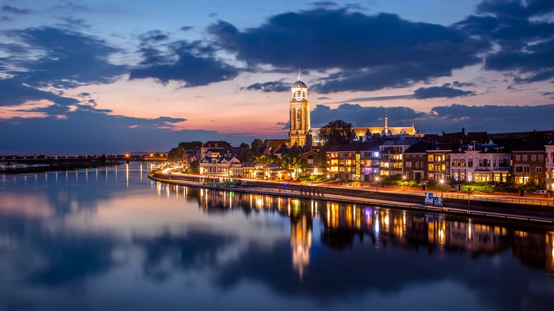 Cityscape with River and Sunset Sky