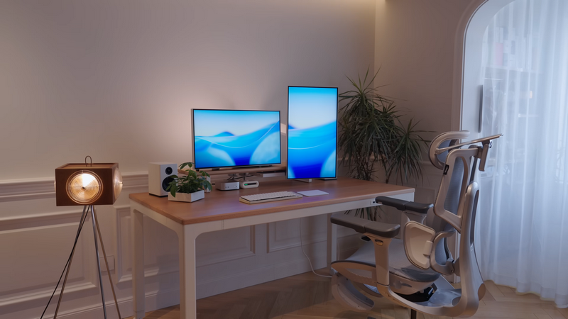 Speakers on a desk with dual computer monitors