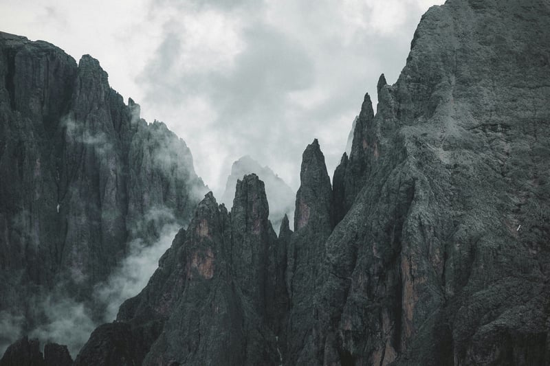 Jagged mountain peaks shrouded in mist