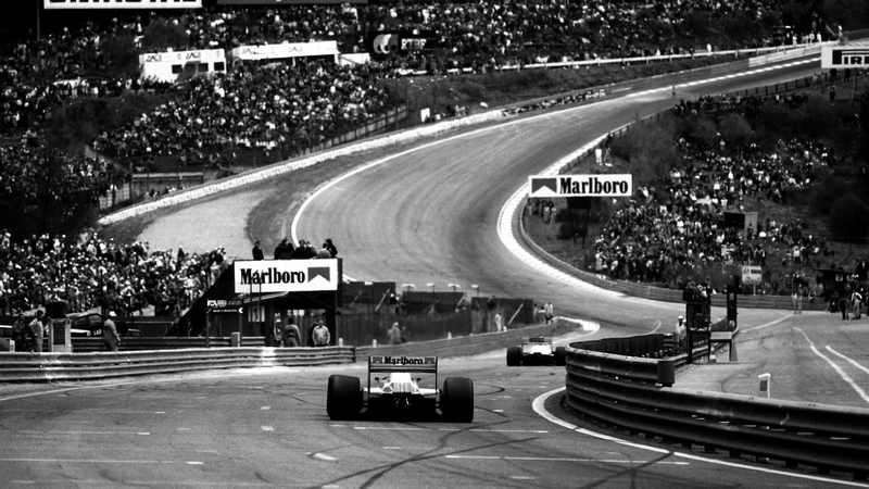 Formula cars race on Spa-Francorchamps with crowds watching