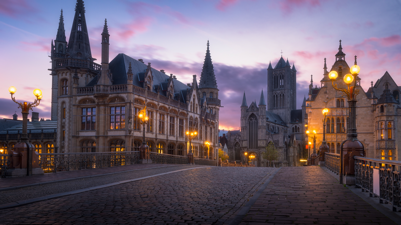 Ghent cityscape with historic architecture and street lights at dusk
