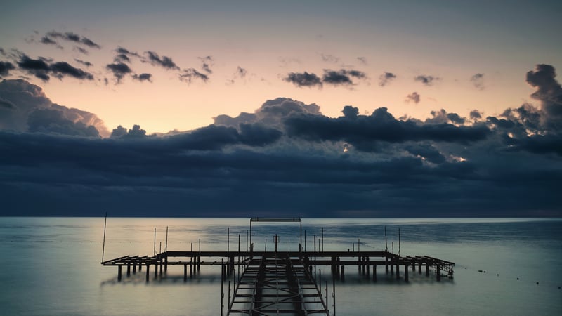 Wooden pier on the sea under storm clouds