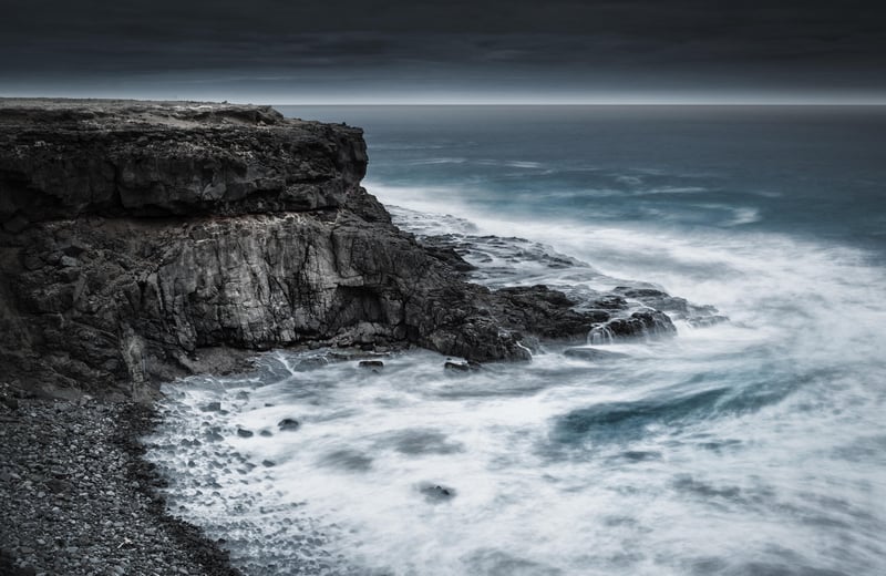 Rocky cliff overlooking the Atlantic Ocean with waves