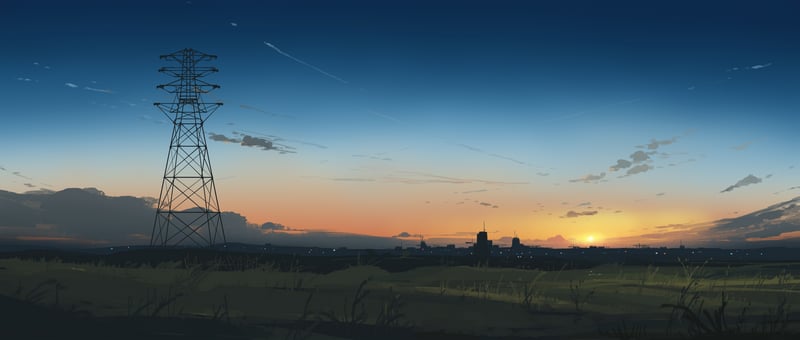 Sunset over a city with a power line tower