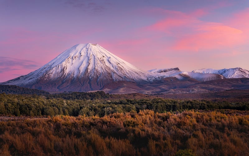 Snowy mountain at sunset with colorful sky