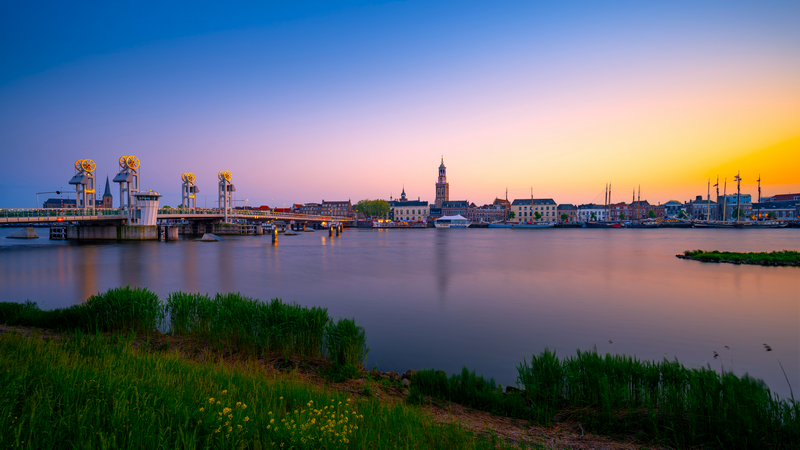 Cityscape with bridge and river at sunset