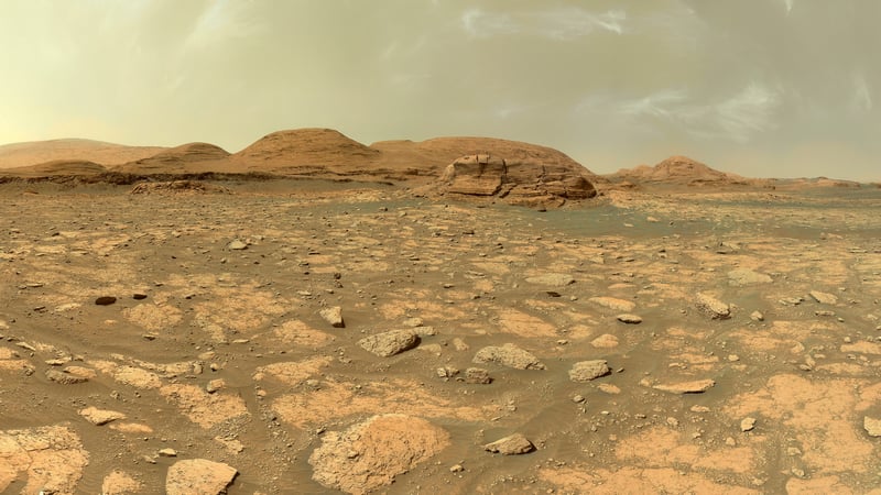 Mars landscape with rocky terrain and hills under a dusty sky