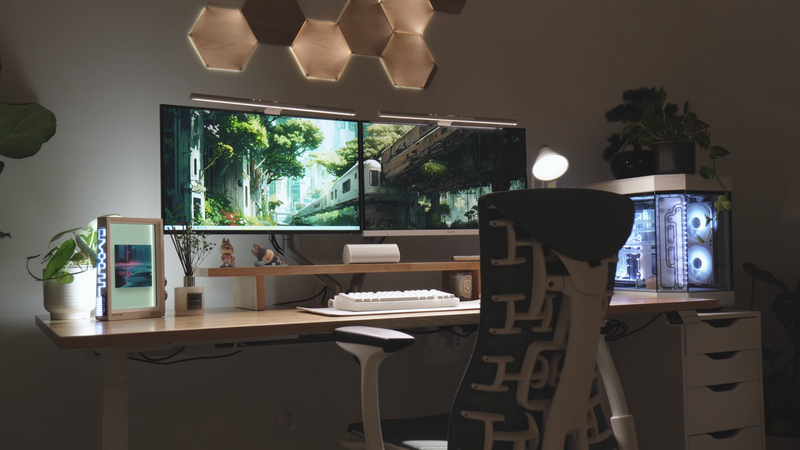Desk setup with dual computer screens and PC
