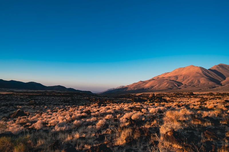 Desert landscape with mountains under a clear blue sky