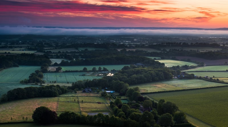 Aerial view of a misty countryside at sunrise