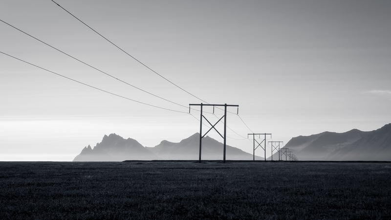 Monochrome landscape with pylons and mountains