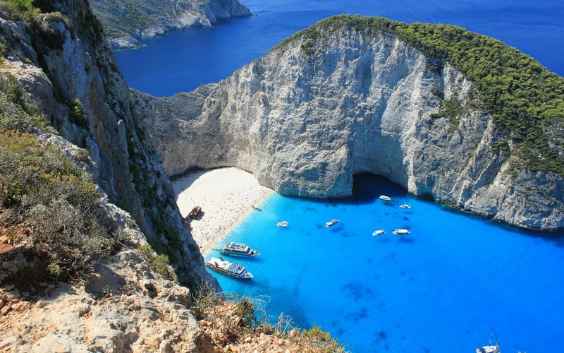 Boats in a turquoise cove at Zakynthos, Greece