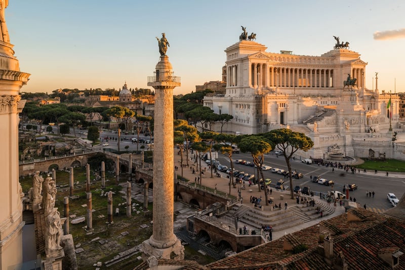 Rome cityscape with ancient ruins and monument at sunset
