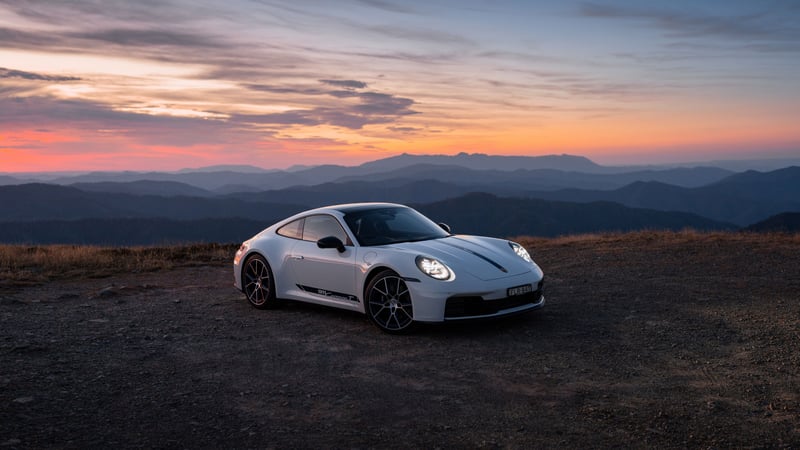 Porsche 991 supercar on a mountain road at sunset