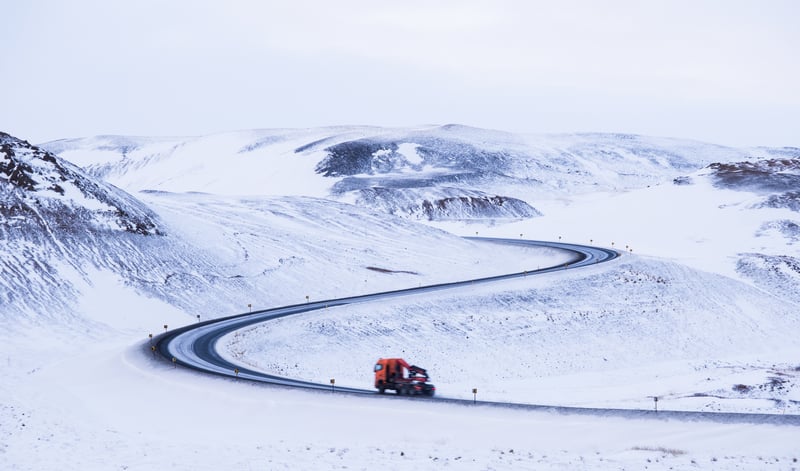 Driving on a winding snowy road in Iceland